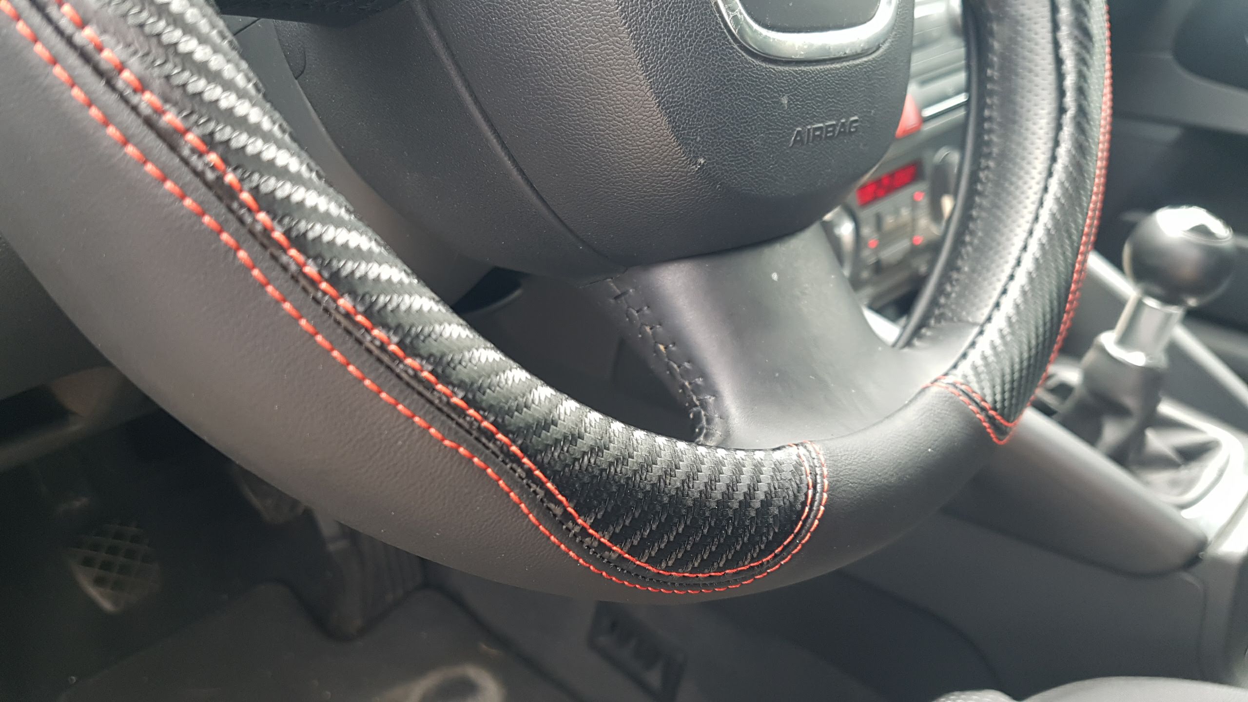 Δερμάτινο κάλυμμα τιμονιού 38 cm - Carbon - κόκκινες ραφές - 1 τμχ. - € 26,9 Δερμάτινο κάλυμμα τιμονιού 38 cm - Carbon - κόκκινες ραφές - 1 τμχ.